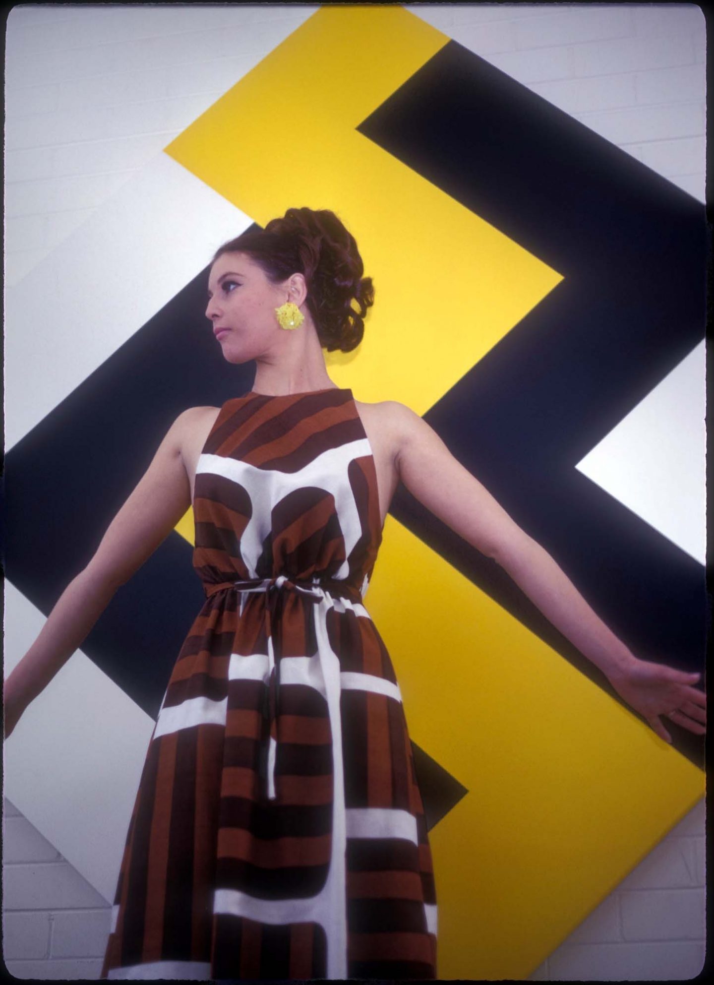 model wearing ‘Zoë’ dress design and ‘John Dallwitz Original Design’ fabric, with Angulate yellow by John Dallwitz, John Gild Galleries, Perth, 1969; photo: John Dallwitz.