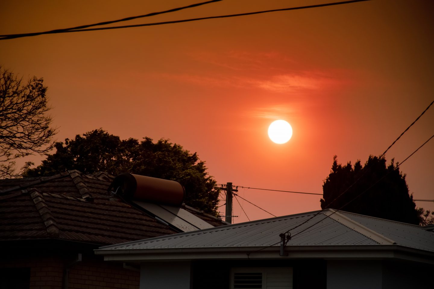 Bushfire smoke creates a red sun over parts of New South Wales