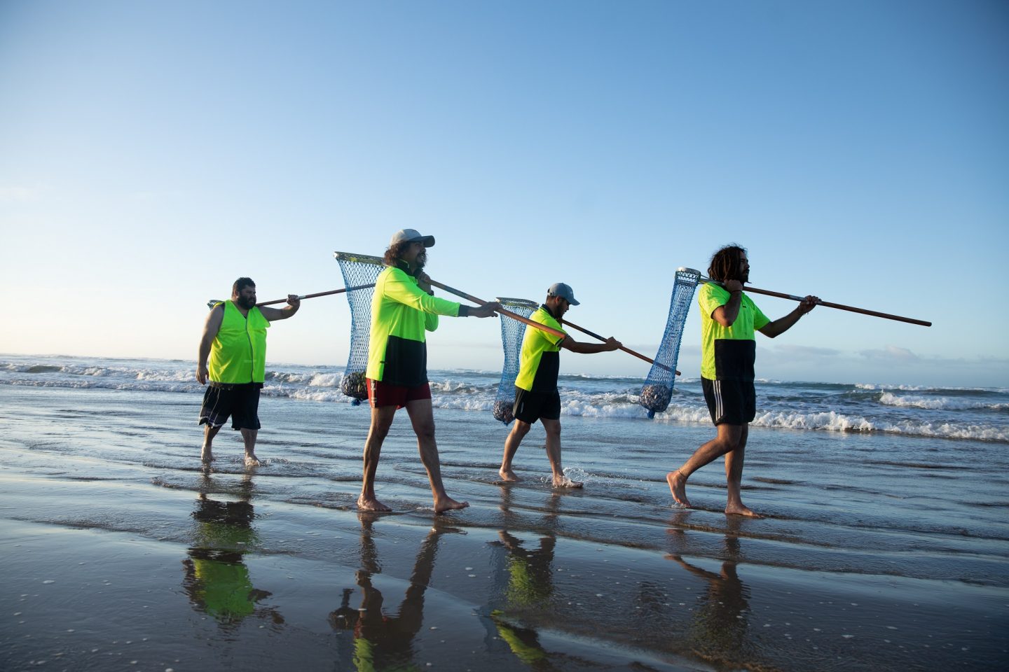 Ngarrindjeri workers harvest pipis from the sand