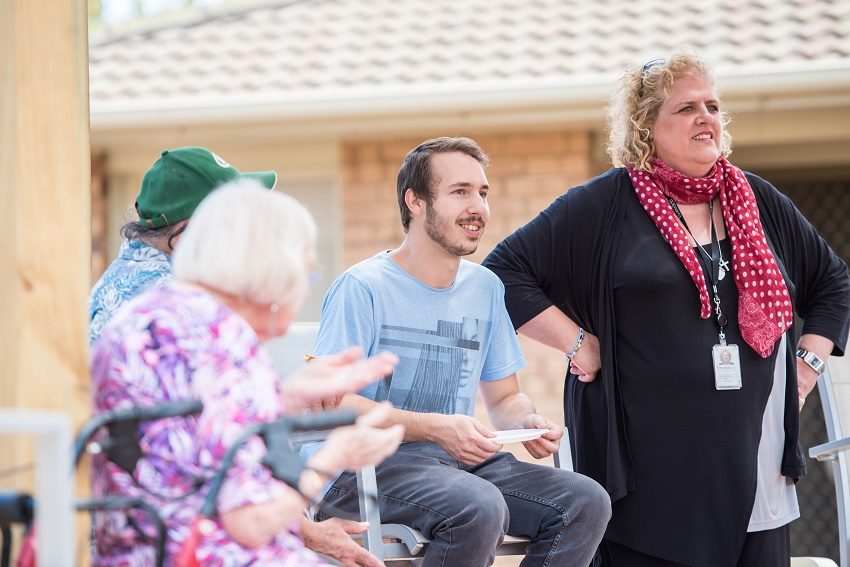Renewal SA Training and Employment Initiatives Manager Samantha Wilson (right) and Works Program graduate Cody with social housing residents celebrating the new shared outdoor space.